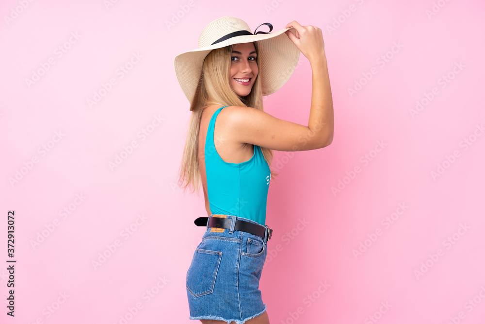 Young blonde Uruguayan woman in swimsuit in summer holidays over isolated pink background Young blonde Uruguayan woman in swimsuit in summer holidays over isolated pink background
