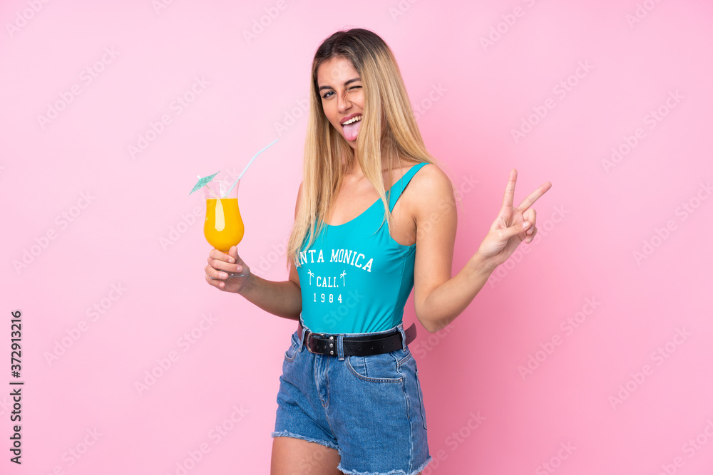 Young blonde Uruguayan woman in swimsuit in summer holidays over isolated pink background Young blonde Uruguayan woman in swimsuit in summer holidays over isolated pink background