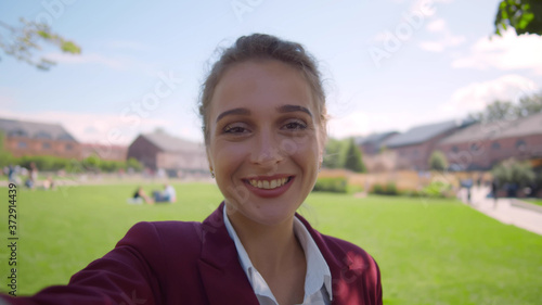 POV shot of young woman communicating online with family or friends on video call at park © TommyStockProject