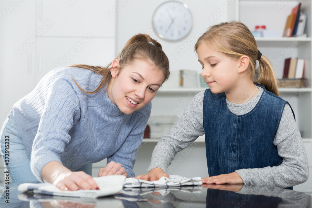 Fototapeta premium Mother and daughter cleans the house. High quality photo
