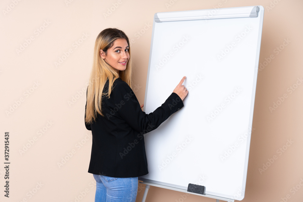 Young Uruguayan woman giving a presentation on white board and writing in it Young Uruguayan woman giving a presentation on white board and writing in it