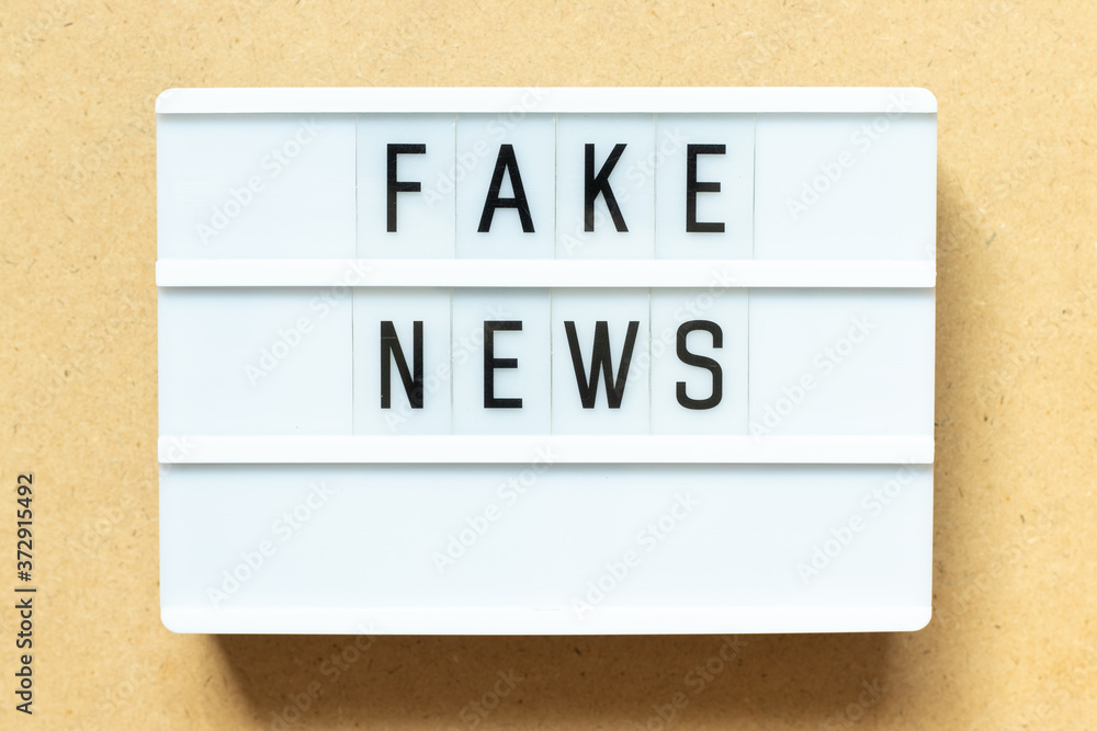 Lightbox with word fake news on wood background Lightbox with word fake news on wood background