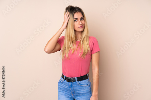Young Uruguayan woman over isolated background having doubts
