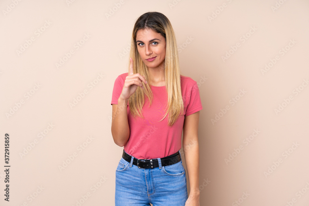 Young Uruguayan woman over isolated background frustrated and pointing to the front Young Uruguayan woman over isolated background frustrated and pointing to the front