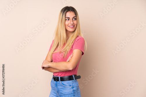 Young Uruguayan woman over isolated background with arms crossed and happy © luismolinero