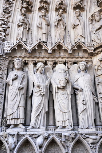 NOTRE DAME CATHEDRAL-17 JULY 2010: Portal statues of Notre Dame Cathedral, St. Denis statue