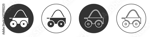 Black Wooden four-wheel cart with hay icon isolated on white background. Circle button. Vector.
