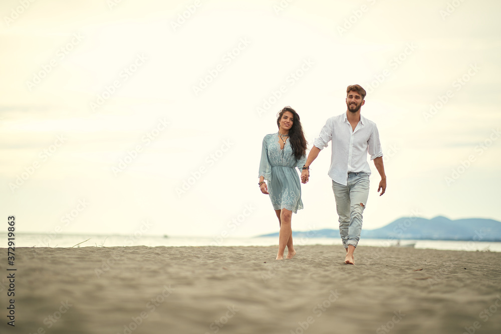 Young couple in love strolling the beach
