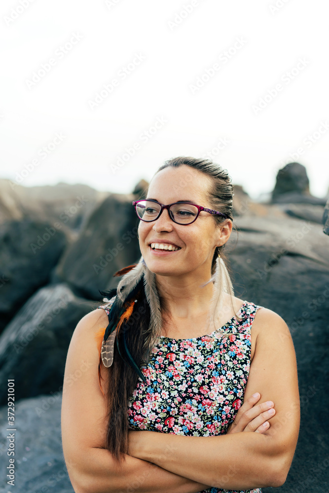 Portrait of a beautiful smart woman wearing glasses. Woman posing and laughing with her arms crossed over her chest.
