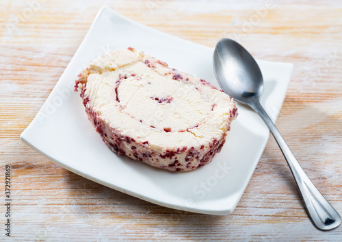Slice of tasty cottage cheese roll filled with cranberries