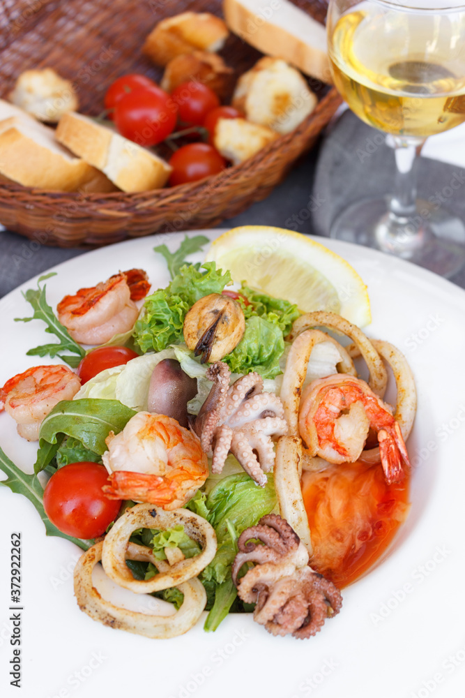 
Seafood salad. Mussels, shrimps, octopuses. Appetizing photo. Mediterranean Kitchen. Nice presentation. An exquisite dish. Close-up. Restaurant menu