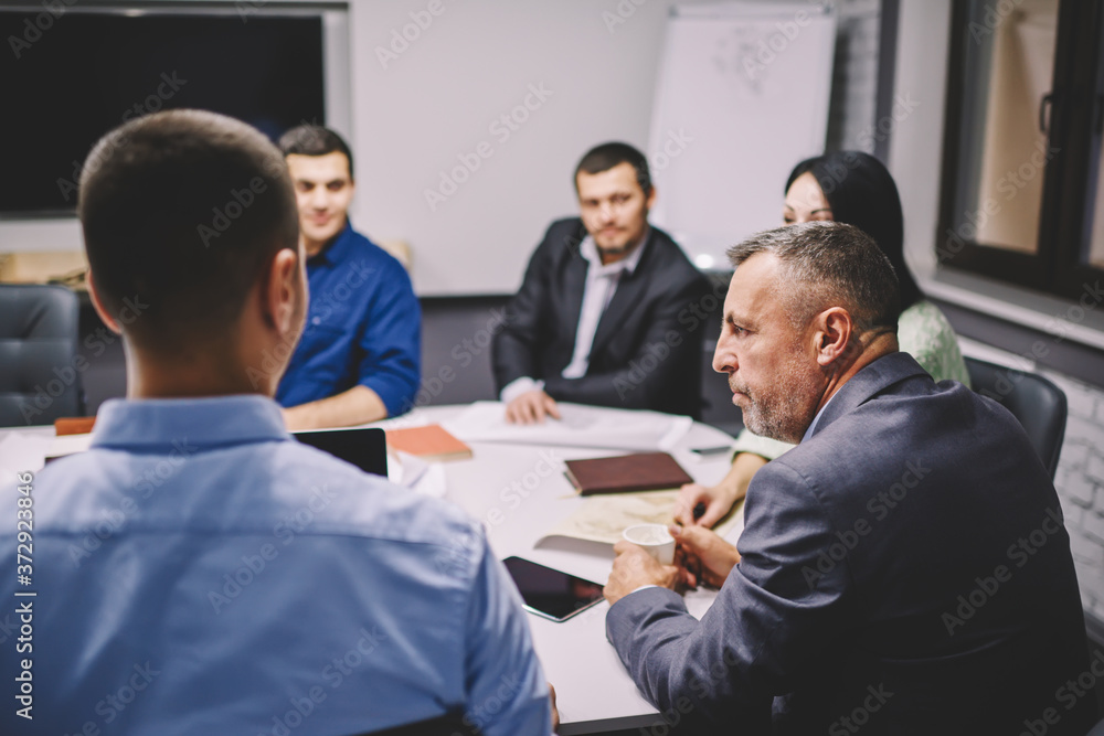 Business colleagues discussing productive strategy of solving problem.Group of male and female professionals with director of company talking about developing new project for entrepreneurship Business colleagues discussing productive strategy of solving problem.Group of male and female professionals with director of company talking about developing new project for entrepreneurship