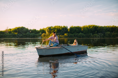 Photography Young family go by boat on the river or lake in summertime