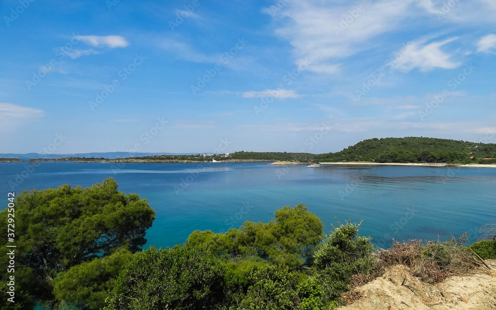 Wild beautiful beach with turquoise water, fine sand and large stones. Greece halkidiki bay. Kassandra on the Halkidiki peninsula.