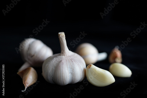 Raw Garlic On Black Background