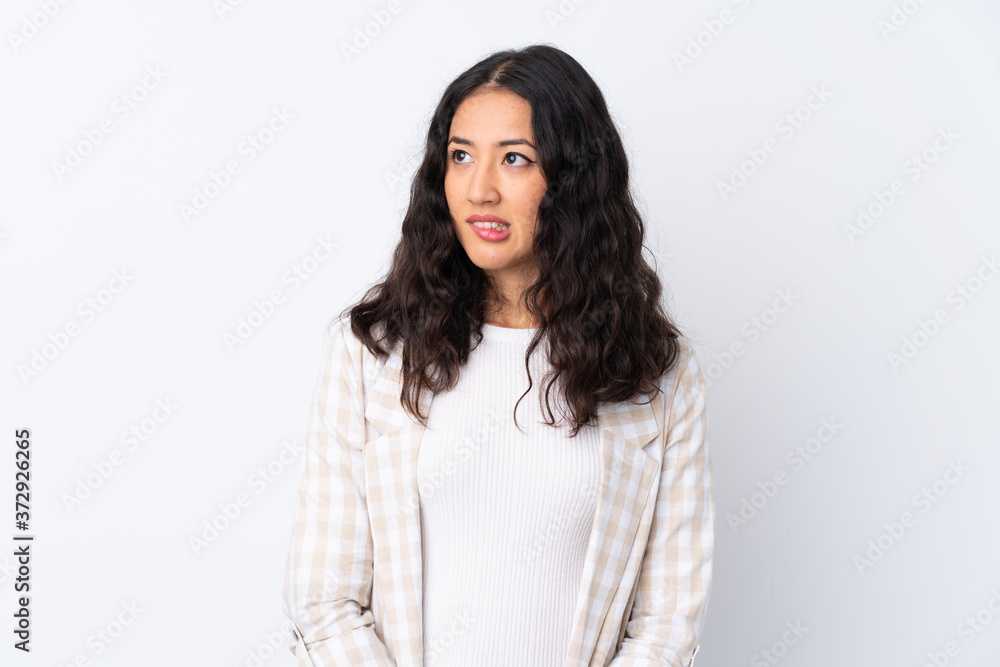 Mixed race woman over isolated white background with confuse face expression Mixed race woman over isolated white background with confuse face expression
