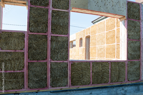 Construction of a house from an environmentally friendly material of plant origin. Frame made of wood, blocks of straw.