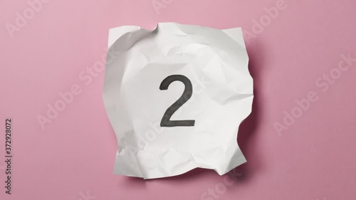 Countdown leader animation 5 to 0 with paper balls wrapping and unwrapping sheet of paper stop motion animation. Combine this clip with others, texture, blank and icons, see my profile for more.