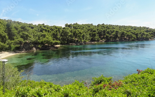 Wild beautiful beach with turquoise water  fine sand and large stones. Greece halkidiki bay. Kassandra on the Halkidiki peninsula.