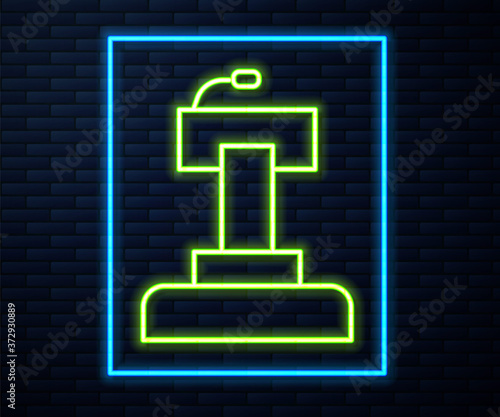 Glowing neon line Stage stand or debate podium rostrum icon isolated on brick wall background. Conference speech tribune. Vector.