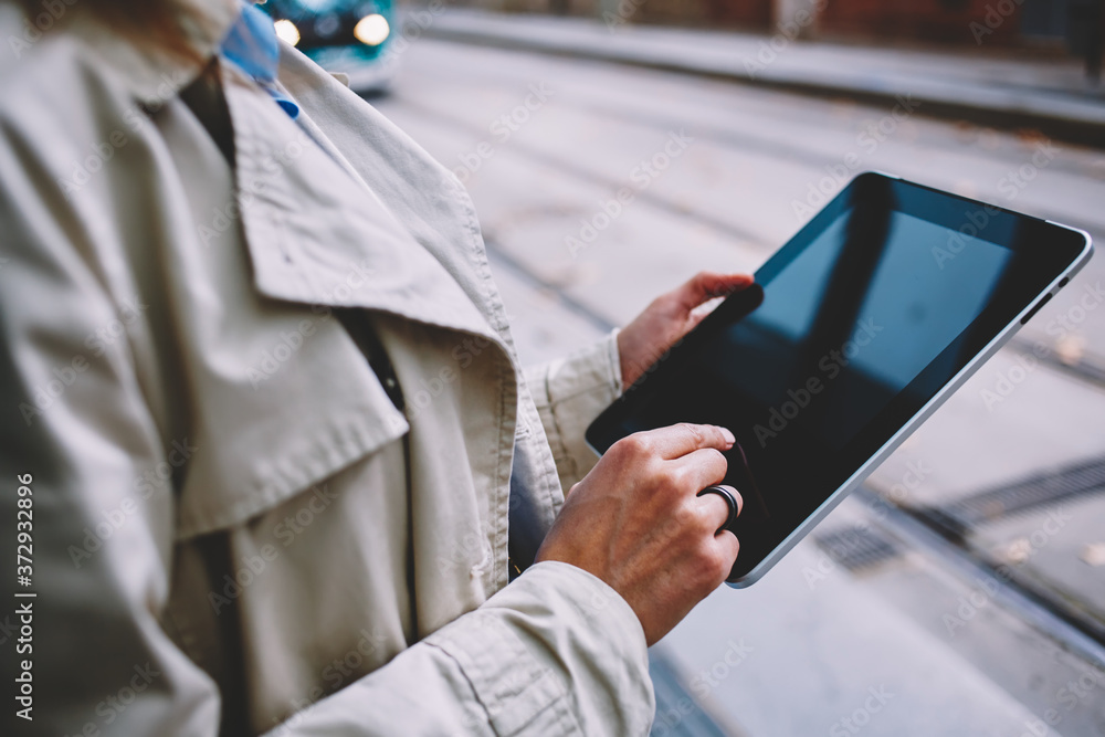 Cropped image of female user searching information on public streams website connected to 4g wireless internet for browsing and installing application, blank touch pad with copy space area Cropped image of female user searching information on public streams website connected to 4g wireless internet for browsing and installing application, blank touch pad with copy space area