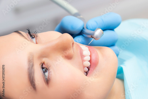 Young Female patient with pretty smile examining dental inspection at dentist clinic. Healthy teeth and medicine  stomatology concept