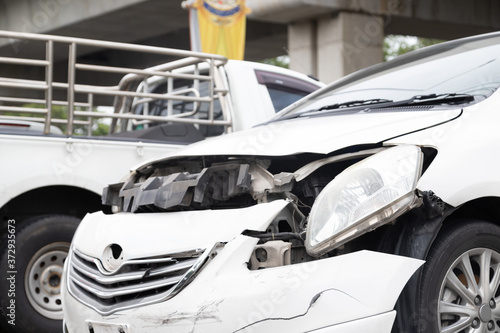 Close-up of front of white car get damaged by accident on the road. concept of road safety © JC_STOCKER