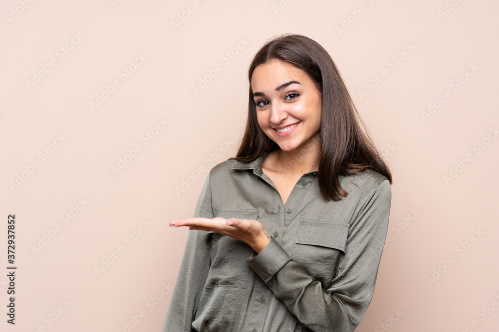 Young girl over isolated background presenting an idea while looking smiling towards Young girl over isolated background presenting an idea while looking smiling towards