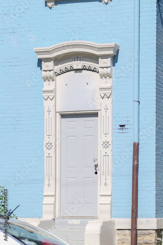 door of a blue Italianate townhouse 
