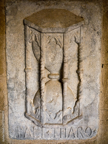 tepus fugit time flies a stone carved hourglass representing the passage of time photo