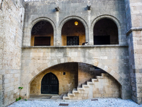 stone architecture building with oval arches doors steps and staircase in rhodes