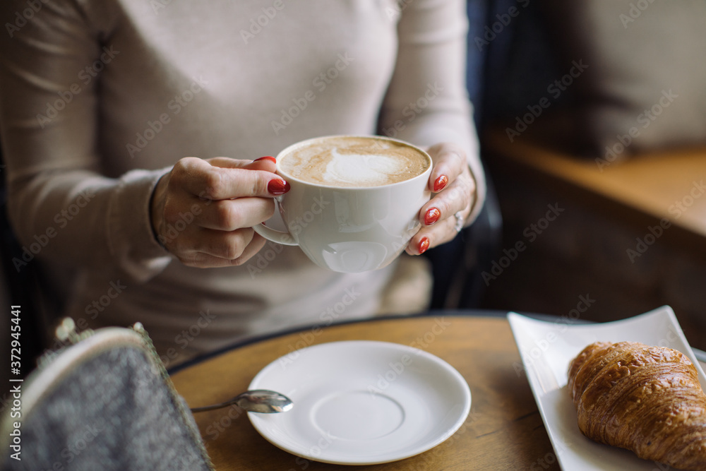 Person having breakfast in cafe and holding big cup of coffee. Person having breakfast in cafe and holding big cup of coffee.