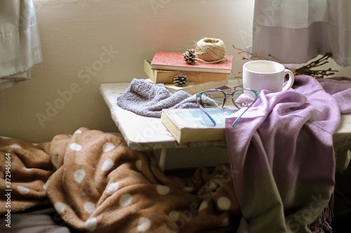 Light and airy bedroom showing concept of comfort, home quarantine and fall season theme