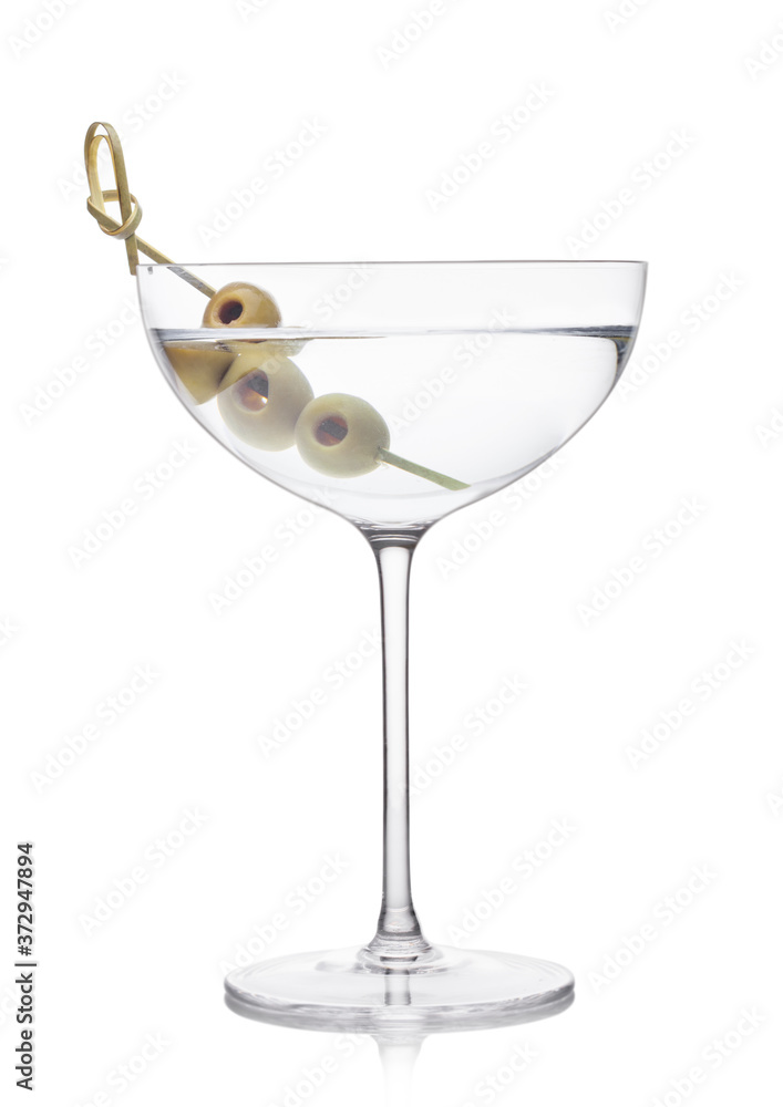 Vodka martini gin cocktail in luxury crystal glass with olives on bamboo stick on white background with reflection. Vodka martini gin cocktail in luxury crystal glass with olives on bamboo stick on white background with reflection.