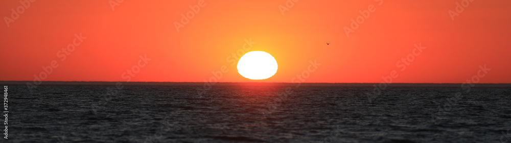 colorful sea sunset and orange sun