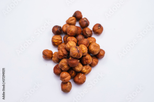 Whole hazelnut kernels lie on a white background. The autumn harvest.