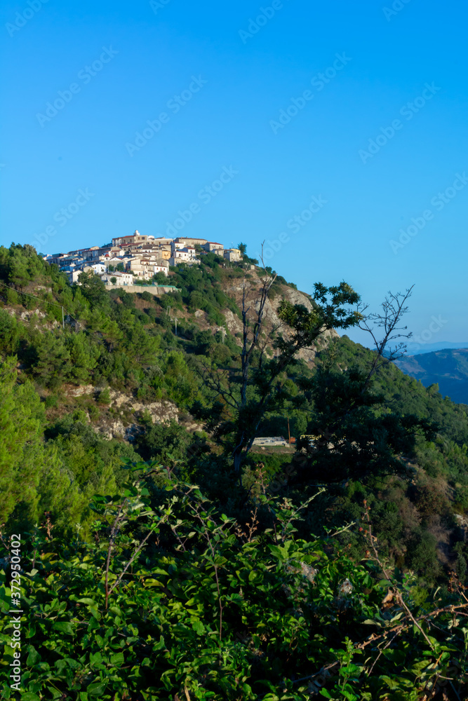 Panoramic View of the small village of Castroregio, in Basilicata, Italy. Summer Sunrise of scenic landscape of a small village in the South of Italy