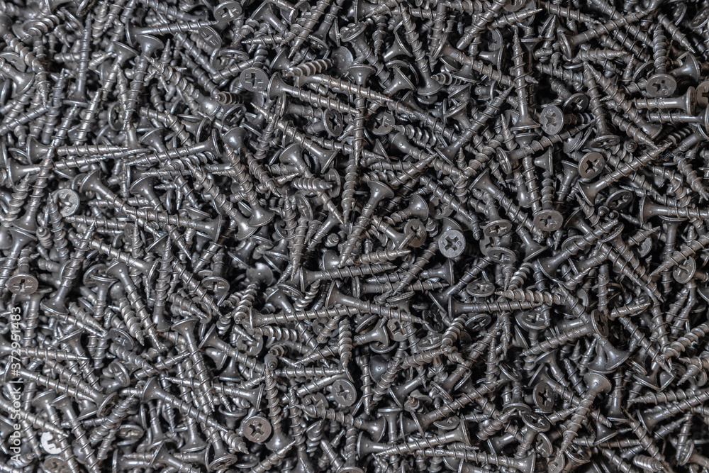Wood screws. Texture. Background for wallpaper. A lot of black screws. View from above. Wood screws. Texture. Background for wallpaper. A lot of black screws. View from above.