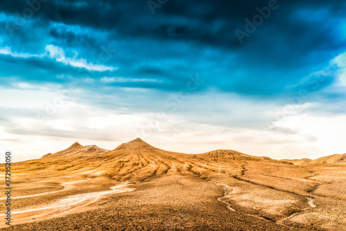 sand dunes in the desert covered by light blue sky. storming over the dessert