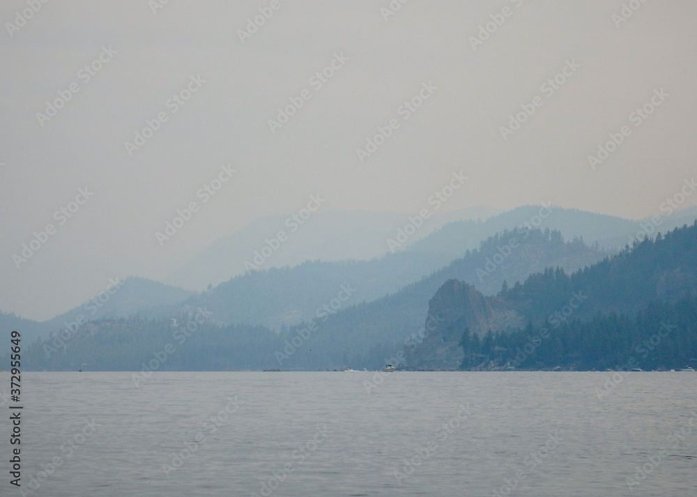 Smokey Skies Over Lake Tahoe and layers of Shrouded Ridgelines from Nevada Beach Nevada in from Wildfires of August 2020 Smokey Skies Over Lake Tahoe and layers of Shrouded Ridgelines from Nevada Beach Nevada in from Wildfires of August 2020
