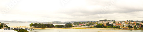 Panoramic photo of a river mouth with a village