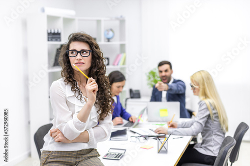 Portrait of business office with busy workers.