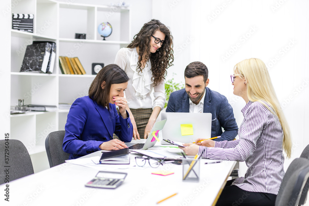 Photo of successful business team working on some project at the office. Photo of successful business team working on some project at the office.