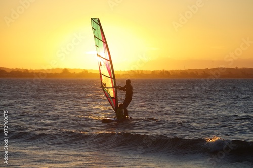 windsurfer on the water at sunset, Rio de Janeiro. Brazil