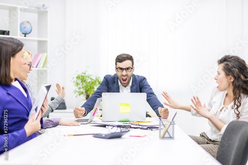 Photo of startup business team on meeting in modern bright office interior.