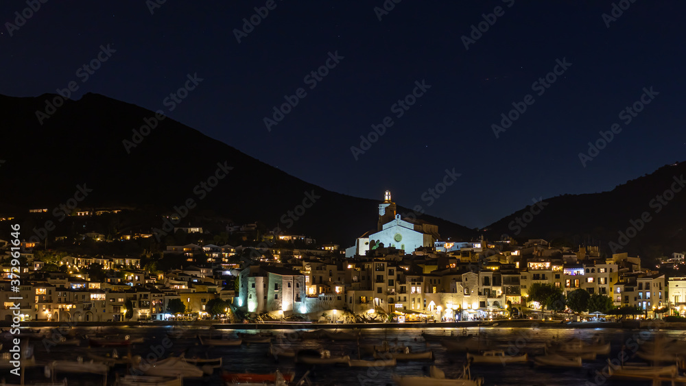 Night panoramic view of Cadaques, Catalonia, Spain. Mountains and  stars on the background. Deep night.