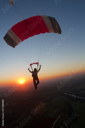 skydiver flying alone in the sunset