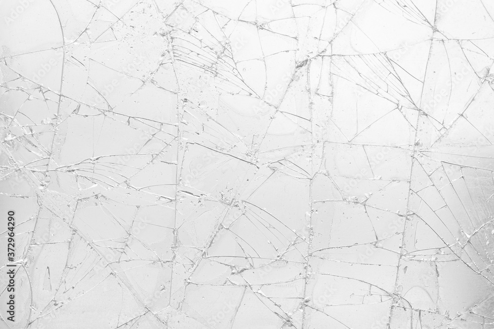 White cracked glass texture background. Texture broken glass window with cracks. Broken screen. White cracked glass texture background. Texture broken glass window with cracks. Broken screen.