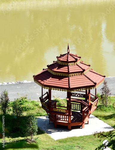 Thai wooden pavilion stands outstandingly beside the pond and jogging track.