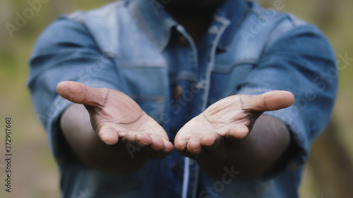 Close up. African man putting the open palms together. High quality photo